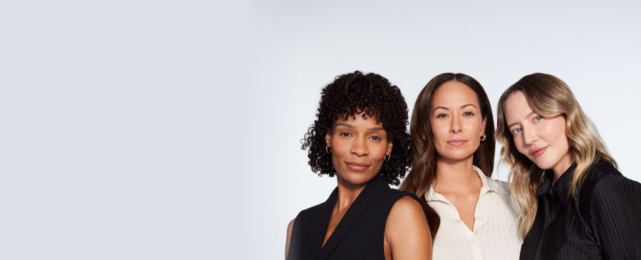 Three female JUVÉDERM pateints pose in front of a blank wall.