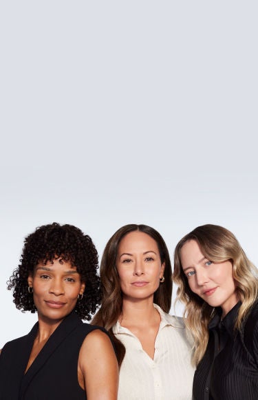 Three female JUVÉDERM pateints pose in front of a blank wall.